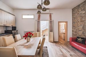 a kitchen and dining room with a table and chairs at Narcê – Coastal Retreat in Porto Cesareo