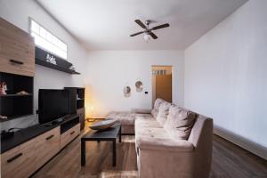 a living room with a couch and a flat screen tv at Narcê – Coastal Retreat in Porto Cesareo