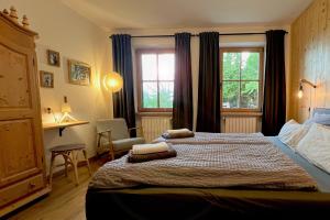 a bedroom with two beds and a window at Valentin36 Apartment Geisler in Funes
