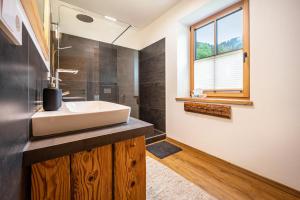 a bathroom with a sink and a window at Valentin36 Apartment Geisler in Funes +37 photos