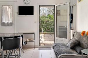 a living room with a couch and a table at M112 - L'orée Du Golf in Pornic
