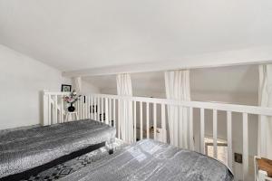 a white room with two beds in it at M112 - L'orée Du Golf in Pornic