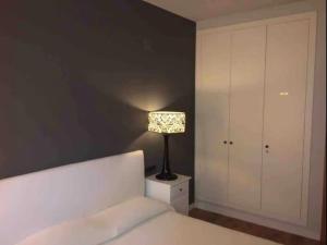 a bedroom with a bed and a lamp on a night stand at Samitier in Cambrils