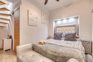 a bedroom with a large bed and a chair at Casa cerca de Marbella in Ojén