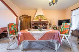 a dining room with a table and two chairs at Appartamento Chia Grande in Chia +18 photos