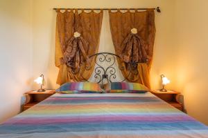 a bedroom with a large bed with two lamps at Appartamento Chia Grande in Chia