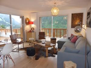 a living room with a couch and a table at Loges blanches b101 Roca immobilier in Châtel