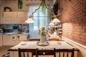 a kitchen with a table with a vase of flowers on it at Villa Mon Paradis in Lucca