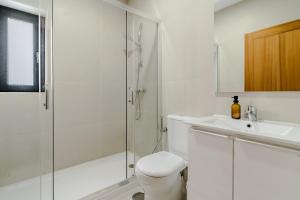 a bathroom with a shower and a toilet and a sink at Casa Feixa Gerês in Geres +12 photos