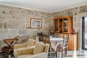 a dining room with a table and chairs at Casa Feixa Gerês in Geres