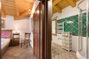 a bathroom with a shower and a bed and a sink at Au Petit Chevrot - Garden in Aosta +210 photos