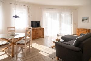a living room with a couch and a table at Bungalow Spinnaker in Ueckermünde