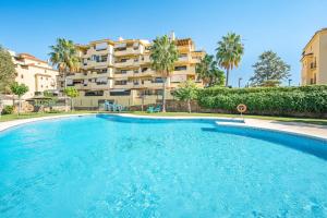 a large swimming pool in front of a building at Apartamento Las Joyas in Estepona