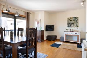 a dining room with a table and a fireplace at Wander Unwind - Wine Cellars in Vila Nova de Gaia