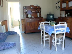 a kitchen with a table with a blue table cloth at Les Flots Bleus Cancale in Cancale