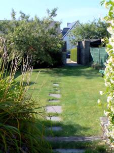 a garden with a path in the grass at Les Flots Bleus Cancale in Cancale