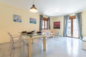a dining room and living room with a table and chairs at P012 Apartment in Cagliari
