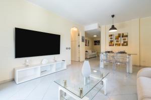 a living room with a flat screen tv on a wall at P012 Apartment in Cagliari