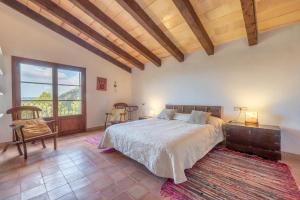 a bedroom with a bed and a large window at Casa Roca Esporles in Esporlas +19 photos