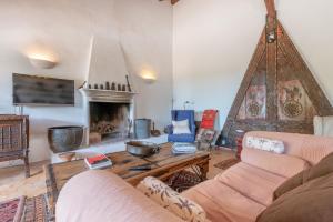 a living room with a couch and a fireplace at Casa Roca Esporles in Esporlas