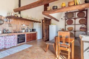 a kitchen with a table and a refrigerator at Casa Roca Esporles in Esporlas