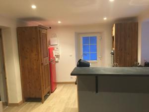 a kitchen with a red refrigerator in a room at Papi Stop in Villarlurin +7 photos