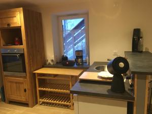 a kitchen with a counter with a sink and a window at Papi Stop in Villarlurin