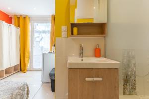 a small kitchen with a sink and a refrigerator at La Dolce Vita 2 in Lambesc +8 photos