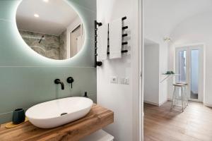 a bathroom with a white sink and a mirror at Casa Quattrocchi in Barano d'Ischia +16 photos