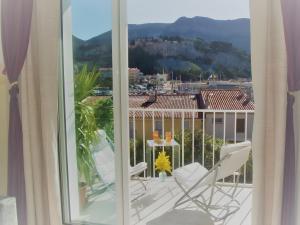 a view of a balcony with chairs and a table at Le Bellavista T2 Cassis Emplacement in Cassis +24 photos