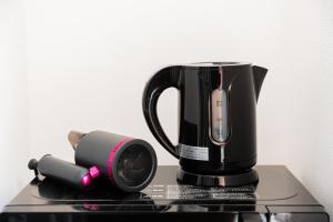 a coffee maker sitting on top of a table at GLOU Akasaka Inn in Tokyo +33 photos