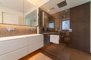 a bathroom with a glass shower and a sink at Levita Living Anima in Tirolo