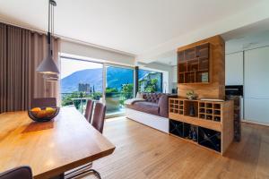 a living room with a table and a couch at Levita Living Anima in Tirolo