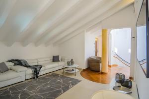 a white living room with a couch and a table at Appartamento Villa Antonia in Marina di Andora