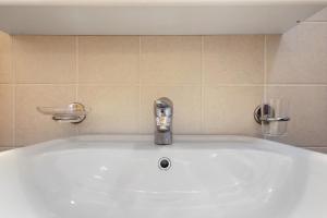 a sink with a faucet in a bathroom at Appartamento Ca' Mocc in Porte di Rendena +13 photos