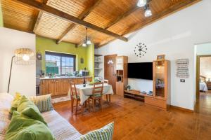 a living room with a couch and a dining room at vv - La Casa Verde in Las Casas