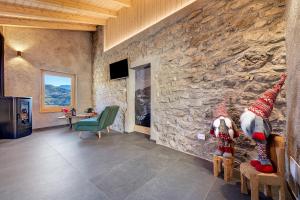 a room with a stone wall with a table and chairs at Chalet Al Volt in Tremosine Sul Garda