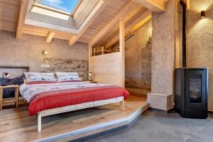 a bedroom with a large bed and a television at Chalet Al Volt in Tremosine Sul Garda