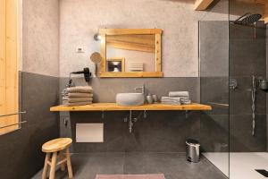 a bathroom with a sink and a mirror at Chalet Al Volt in Tremosine Sul Garda +25 photos