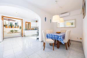 a kitchen and dining room with a table and chairs at Villa Lucia in Portocolom