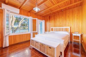 a bedroom with a white bed and a window at Villa Lucia in Portocolom