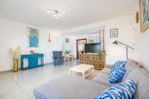 a living room with a couch and a tv at Villa Lucia in Portocolom