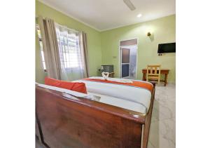 a bedroom with a bed and a dining room at Salpat Camp Lodge in Moshi
