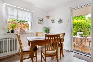 a dining room with a table and chairs and a window at Fewo Sartorius in Bensheim