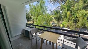 a balcony with a table and chairs and a window at joyful theKrisA205 in Ban Lum Fuang