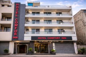 a hotel with a hotel concurrent inn sign in front of it at Hotel Comfort Inn, Nangloi, Walking from Metro in New Delhi