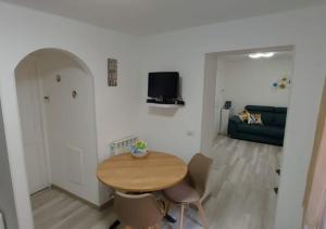a living room with a wooden table and a couch at Casa Elena in Ventimiglia