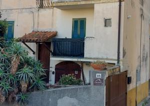 a building with a gate and a balcony with plants at Casa Elena in Ventimiglia