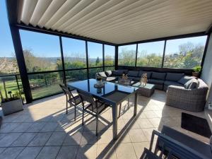 a living room with a table and a couch at Le Cocon Des Roches in Cessieu