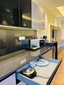 a kitchen with a counter top with a microwave at Cozy haven in Greater Noida